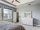 Comfortable bedroom with a neutral color palette and a window offering natural light at 12313 Prairie Plantation Way, Orlando, FL 32824