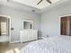 This bedroom features a decorative ceiling, neutral walls, and an adjacent doorway to the bathroom at 12313 Prairie Plantation Way, Orlando, FL 32824