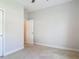 Neutral bedroom with white trim, open white door and carpet provides a blank canvas at 12313 Prairie Plantation Way, Orlando, FL 32824