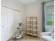 Bright Bedroom features modern baby swing, shelving unit, and natural light from a large window at 12313 Prairie Plantation Way, Orlando, FL 32824