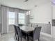 Bright dining room with gray walls, statement art, large windows, and modern lighting at 12313 Prairie Plantation Way, Orlando, FL 32824