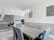 The dining room is open to the kitchen and includes modern lighting and statement art at 12313 Prairie Plantation Way, Orlando, FL 32824