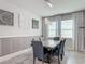 Bright dining room with gray walls, statement art, and large windows at 12313 Prairie Plantation Way, Orlando, FL 32824