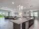 Open-concept kitchen with granite countertops, stainless steel appliances, and modern lighting at 12313 Prairie Plantation Way, Orlando, FL 32824
