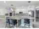Modern kitchen featuring stainless steel appliances, pendant lighting, and barstool seating at 12313 Prairie Plantation Way, Orlando, FL 32824