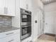 This kitchen has stainless steel appliances and double ovens near an exterior door at 12313 Prairie Plantation Way, Orlando, FL 32824