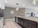A modern kitchen with granite countertops, stainless steel appliances, and a stylish pendant light at 12313 Prairie Plantation Way, Orlando, FL 32824