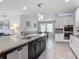 Spacious kitchen with a central island, granite countertops, and stainless steel appliances at 12313 Prairie Plantation Way, Orlando, FL 32824