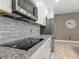Modern kitchen features stainless steel appliances, gray backsplash and granite countertops at 12313 Prairie Plantation Way, Orlando, FL 32824