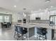 Open concept kitchen with pendant lighting, stainless appliances, barstool seating, and dining room view at 12313 Prairie Plantation Way, Orlando, FL 32824