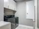 Efficient laundry room with modern appliances and storage cabinets at 12313 Prairie Plantation Way, Orlando, FL 32824