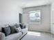 Bright living room with a comfortable sofa and a view of lush tropical foliage at 12313 Prairie Plantation Way, Orlando, FL 32824