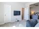 Cozy living room features a large tv, white doors and inviting carpet at 12313 Prairie Plantation Way, Orlando, FL 32824