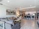 Open-concept living room seamlessly connects to the kitchen with large tile floors and recessed lighting at 12313 Prairie Plantation Way, Orlando, FL 32824