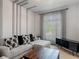 Modern living room featuring a comfortable grey sectional couch and elegant window treatments at 12313 Prairie Plantation Way, Orlando, FL 32824