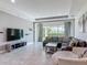 Comfortable living area with large windows offering backyard views and stylish sectional sofa at 12313 Prairie Plantation Way, Orlando, FL 32824
