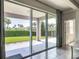 Covered patio with sliding glass doors, offering seamless indoor-outdoor living at 12313 Prairie Plantation Way, Orlando, FL 32824