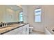 Elegant bathroom featuring double sinks with granite countertops and stylish fixtures at 12537 Encore At Ovation Way, Winter Garden, FL 34787
