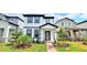 Charming two-story home with landscaped yard, healthy green grass and brick walkway at 12537 Encore At Ovation Way, Winter Garden, FL 34787