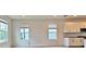 Bright living room with large windows and a view of the street, next to the kitchen at 12537 Encore At Ovation Way, Winter Garden, FL 34787