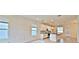 Open-concept living room with plenty of natural light and a kitchen featuring white cabinets at 12537 Encore At Ovation Way, Winter Garden, FL 34787