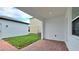 Covered patio featuring brick floor overlooking a cozy backyard at 12537 Encore At Ovation Way, Winter Garden, FL 34787