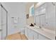Neutral bathroom with white cabinets, granite counters and glass shower doors at 1428 Reunion Blvd, Kissimmee, FL 34747