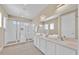 Modern bathroom with double vanity, quartz countertops, and walk-in glass shower with a built-in bench at 1428 Reunion Blvd, Kissimmee, FL 34747