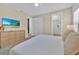 Light beige bedroom with TV and ample closet space at 1428 Reunion Blvd, Kissimmee, FL 34747