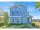 Charming two-story blue home with white trim, shutters, and a manicured front yard at 1428 Reunion Blvd, Kissimmee, FL 34747