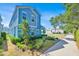 Stylish two-story home featuring vibrant blue siding and manicured landscaping, with a sidewalk at 1428 Reunion Blvd, Kissimmee, FL 34747