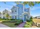 Inviting two-story home with blue siding and a well-maintained front yard and brick sidewalk at 1428 Reunion Blvd, Kissimmee, FL 34747