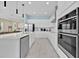 Bright kitchen featuring white cabinets, stainless steel appliances, and a spacious quartz countertop at 1428 Reunion Blvd, Kissimmee, FL 34747