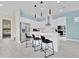 Modern kitchen with stainless steel appliances, a large island with seating, and sleek finishes at 1428 Reunion Blvd, Kissimmee, FL 34747
