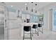 Stylish kitchen featuring white cabinets, a central island with seating, and modern lighting at 1428 Reunion Blvd, Kissimmee, FL 34747
