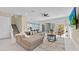 Bright open-plan living room featuring tile flooring, large sectional sofa, and sliding glass doors at 1428 Reunion Blvd, Kissimmee, FL 34747