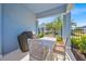Covered patio features a white dining set, BBQ grill, black metal fencing, and lush green landscaping at 1428 Reunion Blvd, Kissimmee, FL 34747