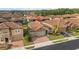 Aerial view of a home in a well-maintained community featuring tile roofs, lush landscaping, and paver driveways at 1631 Nina Dr, Davenport, FL 33837