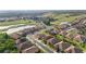 Aerial view of a well-maintained neighborhood near a golf course and a peaceful lake at 1631 Nina Dr, Davenport, FL 33837