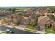 Aerial view of a well-maintained home featuring a tile roof, lush landscaping, and a paver driveway at 1631 Nina Dr, Davenport, FL 33837