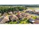 Aerial view of a neighborhood showcases mature landscaping and a peaceful pond at 1631 Nina Dr, Davenport, FL 33837
