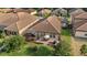 Backyard aerial view features a screened-in patio and an open patio with a table and a grill at 1631 Nina Dr, Davenport, FL 33837