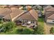 Backyard aerial view features a screened-in patio and an open patio with a table and a grill at 1631 Nina Dr, Davenport, FL 33837