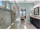 Bathroom featuring tiled shower, glass door, and a vanity with granite countertop at 1631 Nina Dr, Davenport, FL 33837