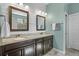 Elegant bathroom featuring double sinks with granite countertop, modern lighting, and neutral color palette at 1631 Nina Dr, Davenport, FL 33837