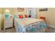Bedroom featuring a colorful quilt, tile floor, and plenty of light at 1631 Nina Dr, Davenport, FL 33837