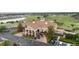 Aerial view showcases the clubhouse entrance with lush landscaping and golf course views at 1631 Nina Dr, Davenport, FL 33837