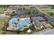 An aerial view of the community pool with water slides, a playground, and tennis courts at 1631 Nina Dr, Davenport, FL 33837