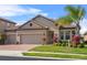 Charming home with a tile roof, brick driveway, and well-manicured landscaping at 1631 Nina Dr, Davenport, FL 33837