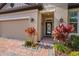 Inviting front entrance with brick walkway and lush landscaping at 1631 Nina Dr, Davenport, FL 33837